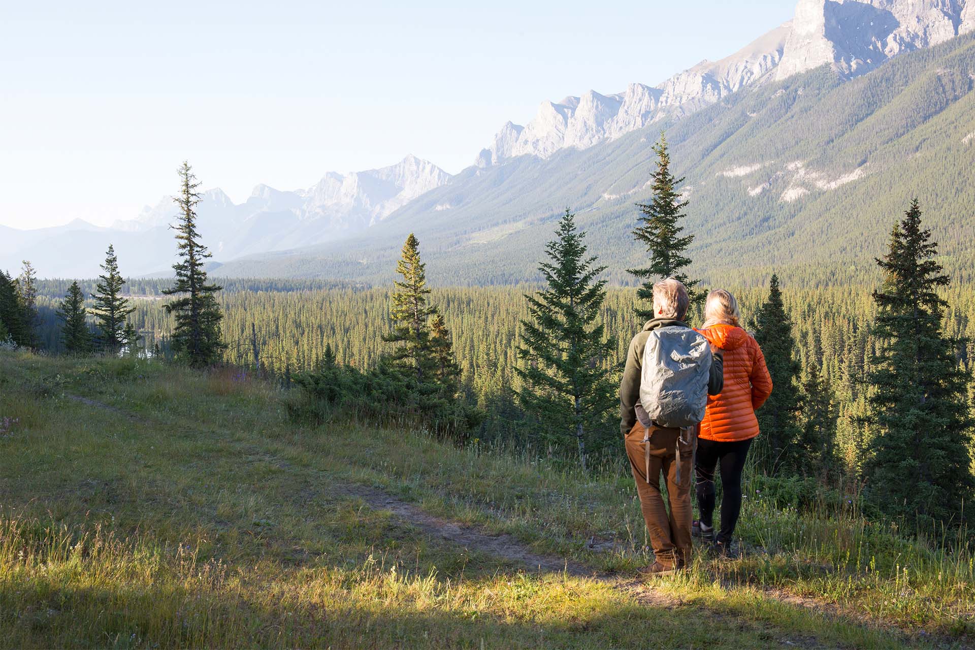 older_couple_hiking_in_meadow
